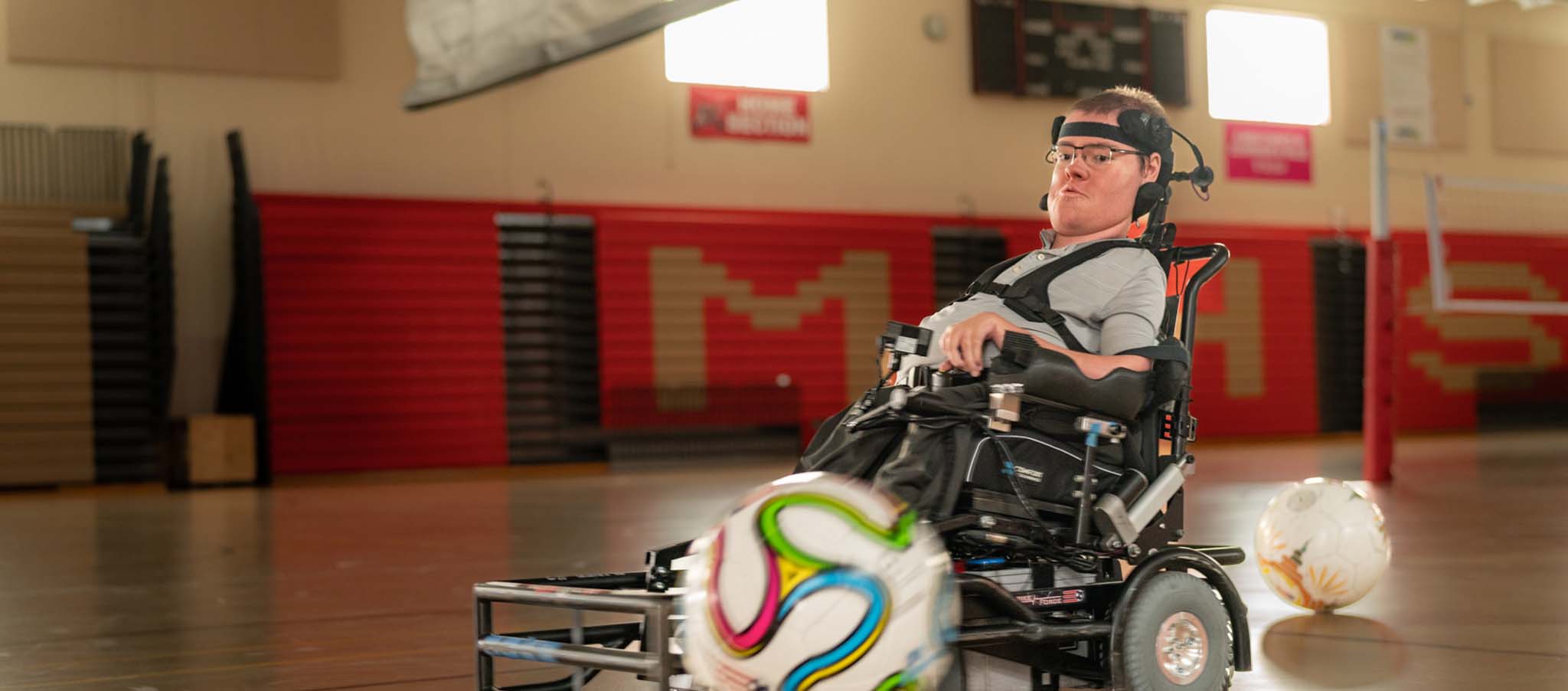 Nathan en un gimnasio jugando con un balón de fútbol